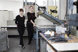 Picture shows two female students in a lab of printing.